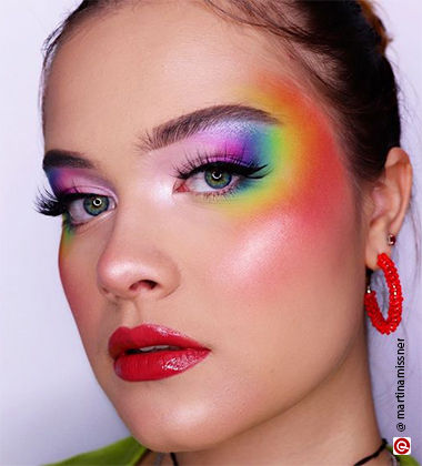 Woman wearing rainbow makeup on eyes and face