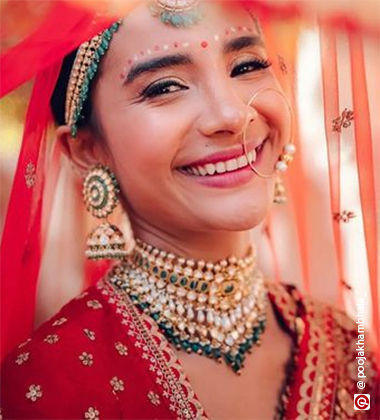 Woman wearing natural makeup with red lehenga