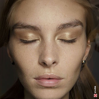 Bare face with gold eyeshadow
                                                                                                                                                 
