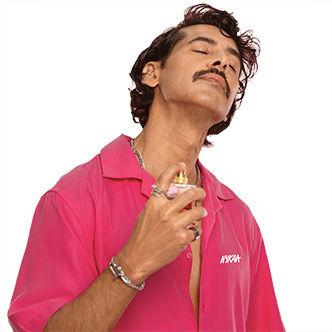 Dino Morea in pink spritzing perfume on his neck