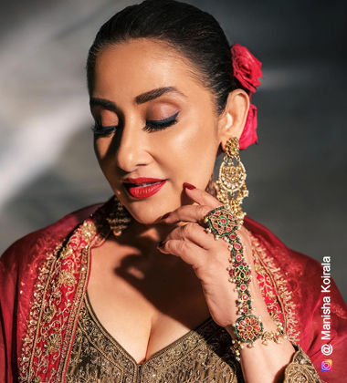 Manisha Koirala wearing bold red lipstick and fake lashes
