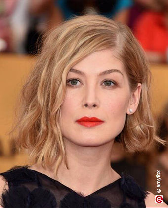 Rosamund Pike with wavy hair in an asymmetric bob