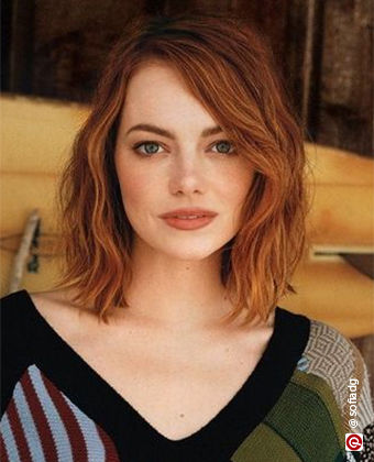 Emma Stone with wavy hair in a side fringe lob