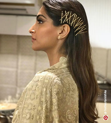 Sonam Kapoor in open hair and criss-cross bobby pins hairstyle
