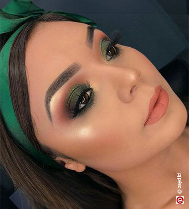 woman wearing a green headband and eyeshadow