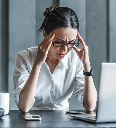 woman in office with her hands in her hair