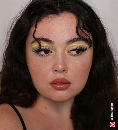 woman with open hair and yellow eyeliner