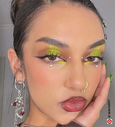 woman with her face sitting on her hand and mustard yellow eyeshadow