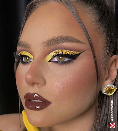 woman with a yellow diamond earring and yellow eyeshadow