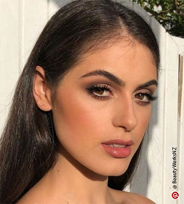 woman with open black hair and looking towards the camera