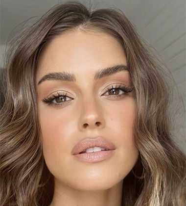 woman in wavy hair close up of makeup