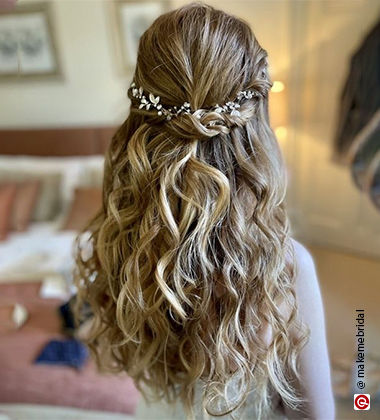 Woman wearing white with garlands in her twisted upper half of her hair