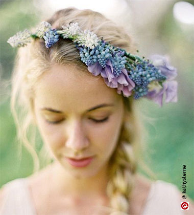 woman wearing white looking sideways with purple flowers