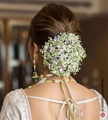 woman with a low bun full of flowers