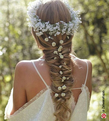 woman wearing a loose white dress with a fishtail braid