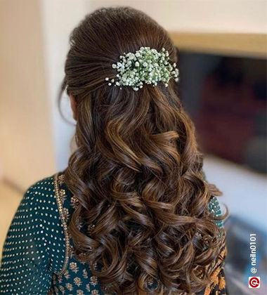 woman wearing a blue outfit with gajra in her hair