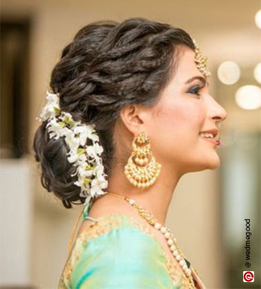 woman’s side profile in a green saree