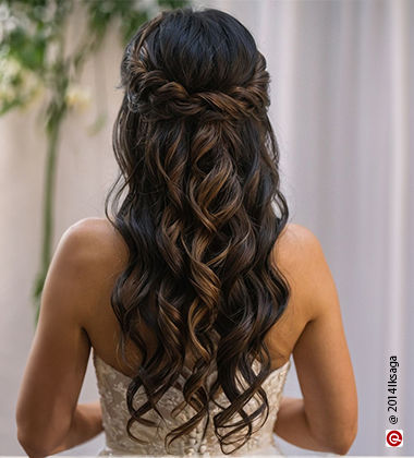 back of a woman wearing a white dress and twisted curls